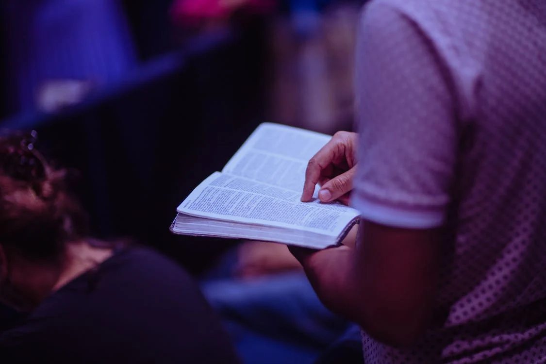 Photo of Person Holding Book